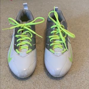 Nike cleats in white with neon yellow accents